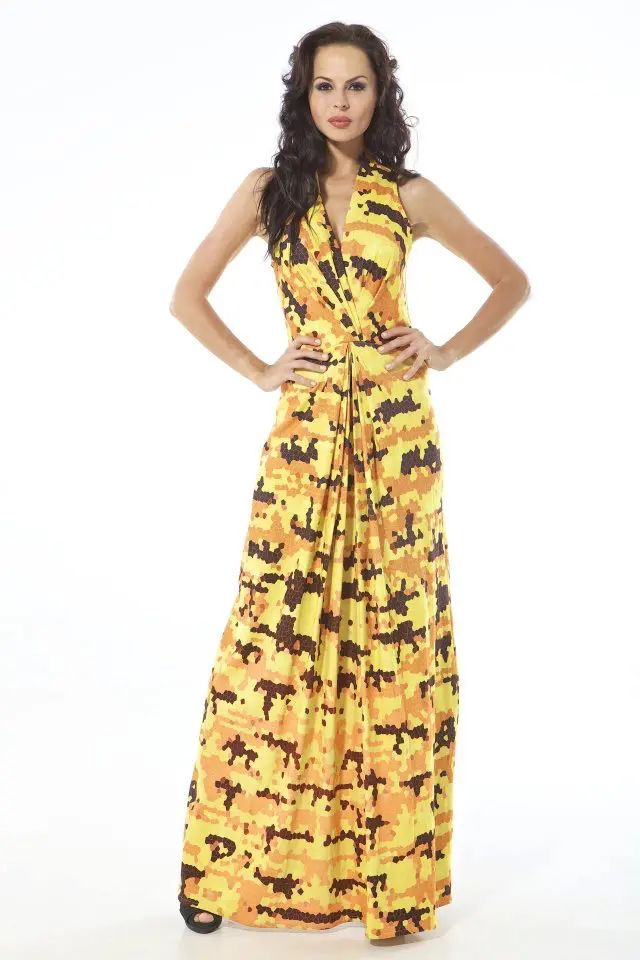 This dress is designed for warm evenings, with a casual but graphic silhouette. Made from soft cotton jersey, it features knots at the shoulders, a bikini-inspired bodice, and a pointed hemline that creates movement and a touch of asymmetry. The surface is printed with a grunge-style mirrored pattern, blending sunset tones—yellow, orange, red—with deep black, evoking reflections, distortion, and raw texture. The look is lightweight, easy to wear, and bold in visual language—continuing Resort 2013’s approach of combining graphic prints with relaxed construction, balancing playfulness and edge in one piece.